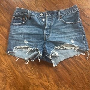 Levi’s 501 distressed button up Jean shorts. Medium wash